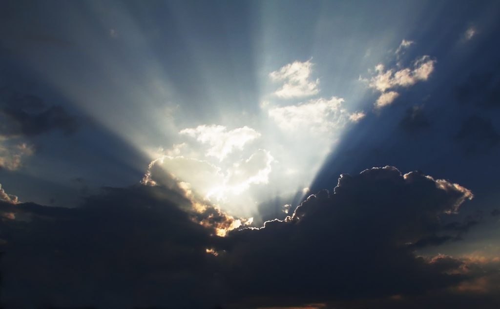 Sunburst rays over a cosmic background